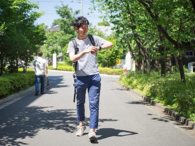 student-walking-watch-outside