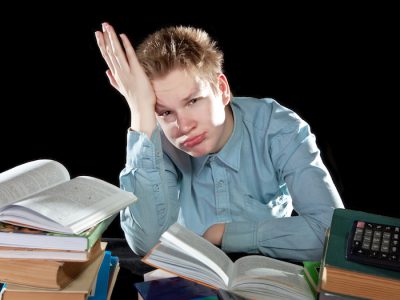 study-test-tired-student-man-heap-textbooks